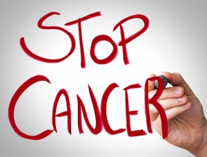 "Stop Cancer" Hand writing with red marker on transparent wipe b
